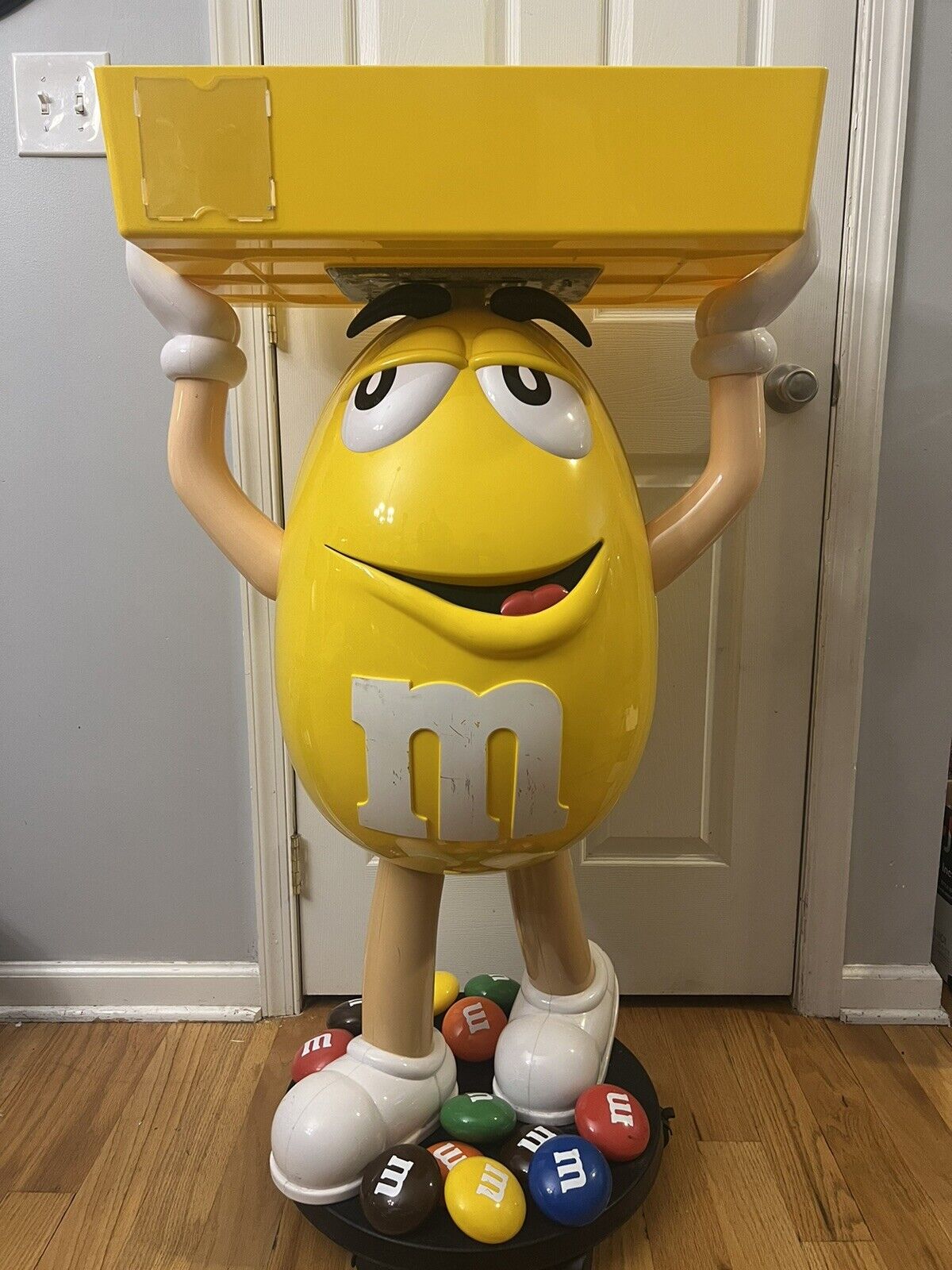 Yellow M&M Guy Store Display With Tray On Wheels