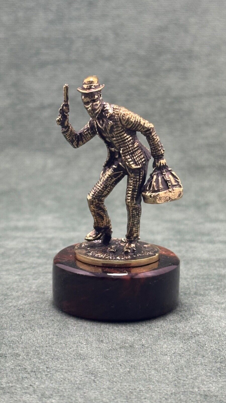 Art Deco. Figurine of a robber,  cast bronze, pedestal Obsidian stone.