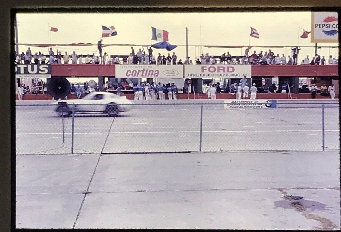 1960\'s Sebring FL 12 hour 1965 Race Car in motion blue flag Pit Crew 