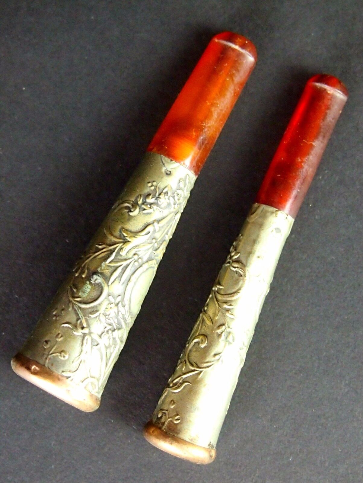 2 CIGARETTE MOUTHPIECE. AMBER. SILVER PLATED METAL. HAND CHISELLED. SPAIN. XIX.