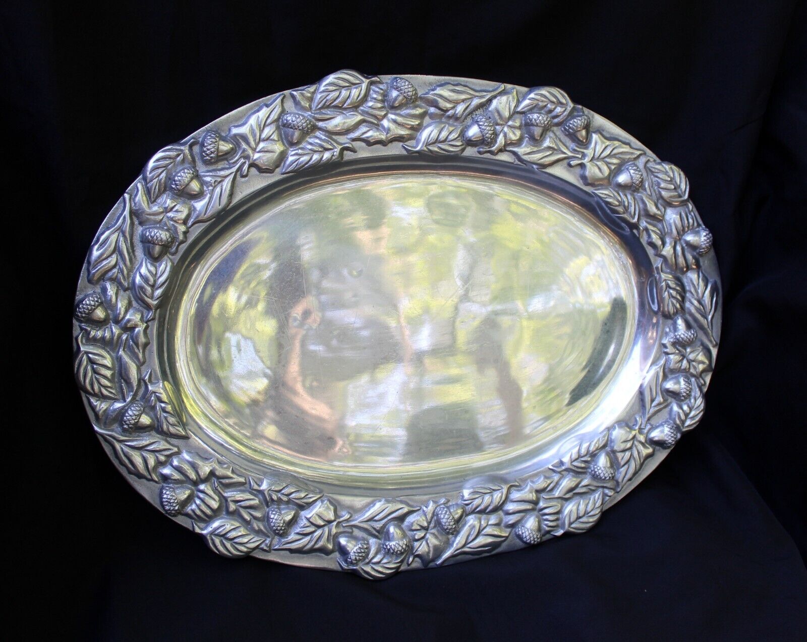 Oval pewter platter rimmed with a lovely pattern of acorns and leaves.  