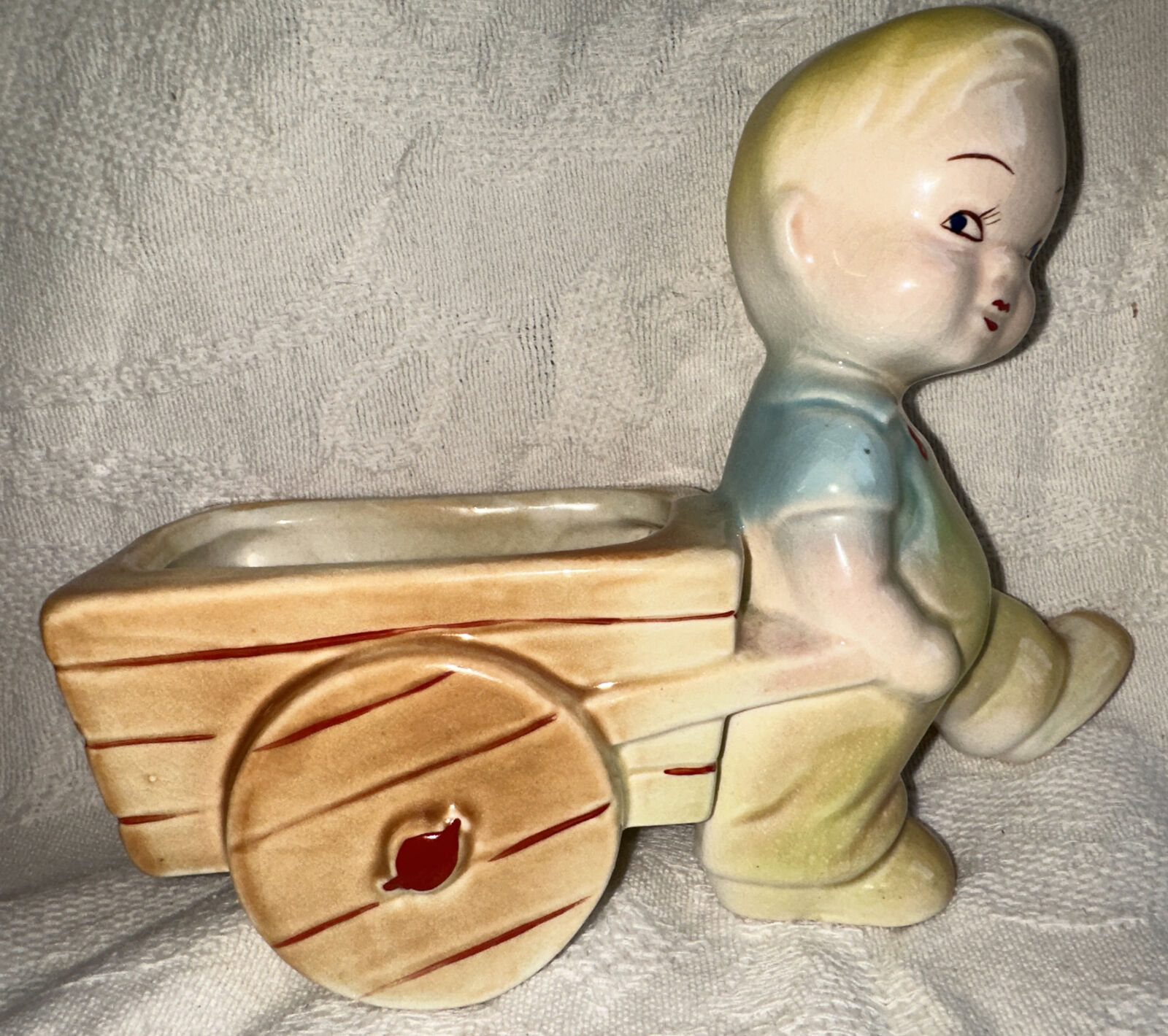 Shawnee Planter Vintage Blond Boy in overalls pulling a cart