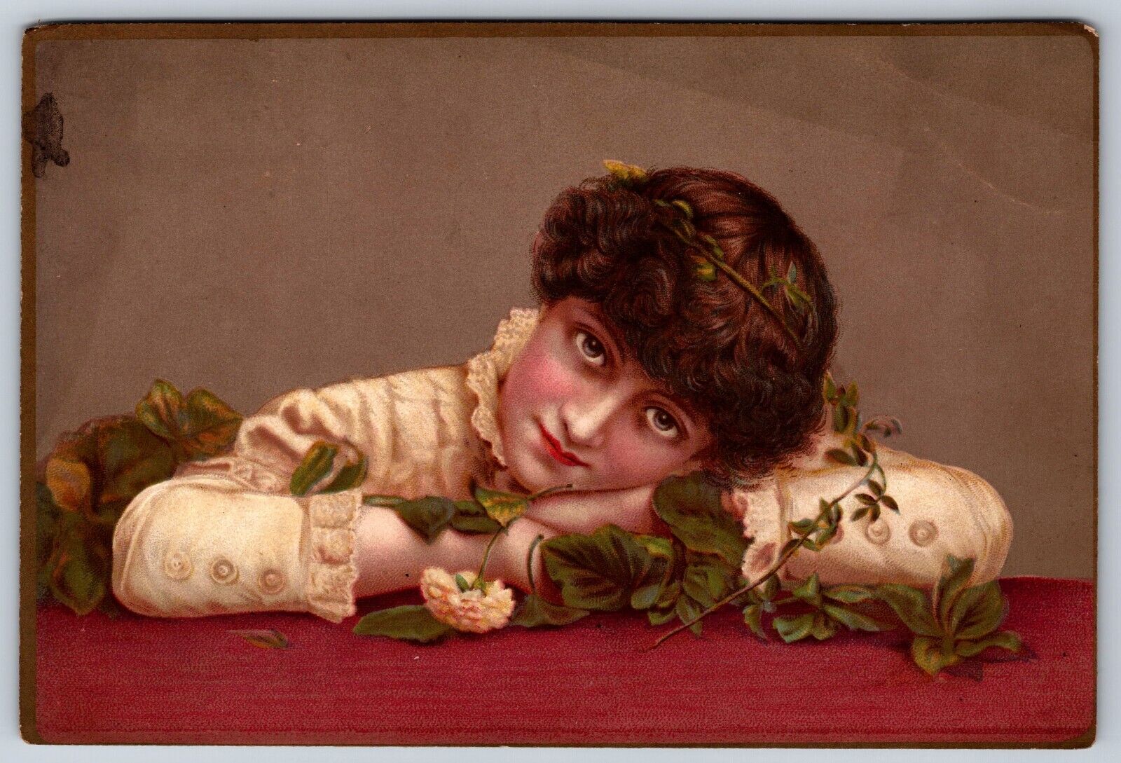 Victorian era trading card, girl with her head down on table with rose leaves