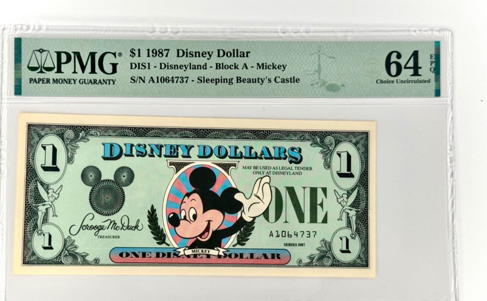 1987 $1 Disney Dollar - Waving Mickey - 1 St Run with Error PMG64 (S/N A1064737)