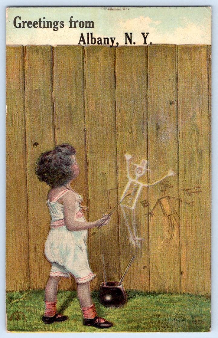 1912 GREETINGS FROM ALBANY NY CHILD PAINTS GRAFFITI ON WOOD FENCE POSTCARD