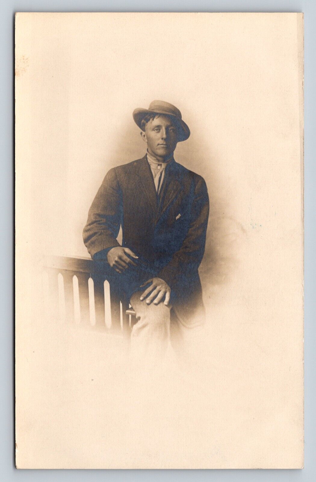 c1911 RPPC Man Sits on Arm of Chair in Suit and Tilted Hat ANTIQUE Postcard
