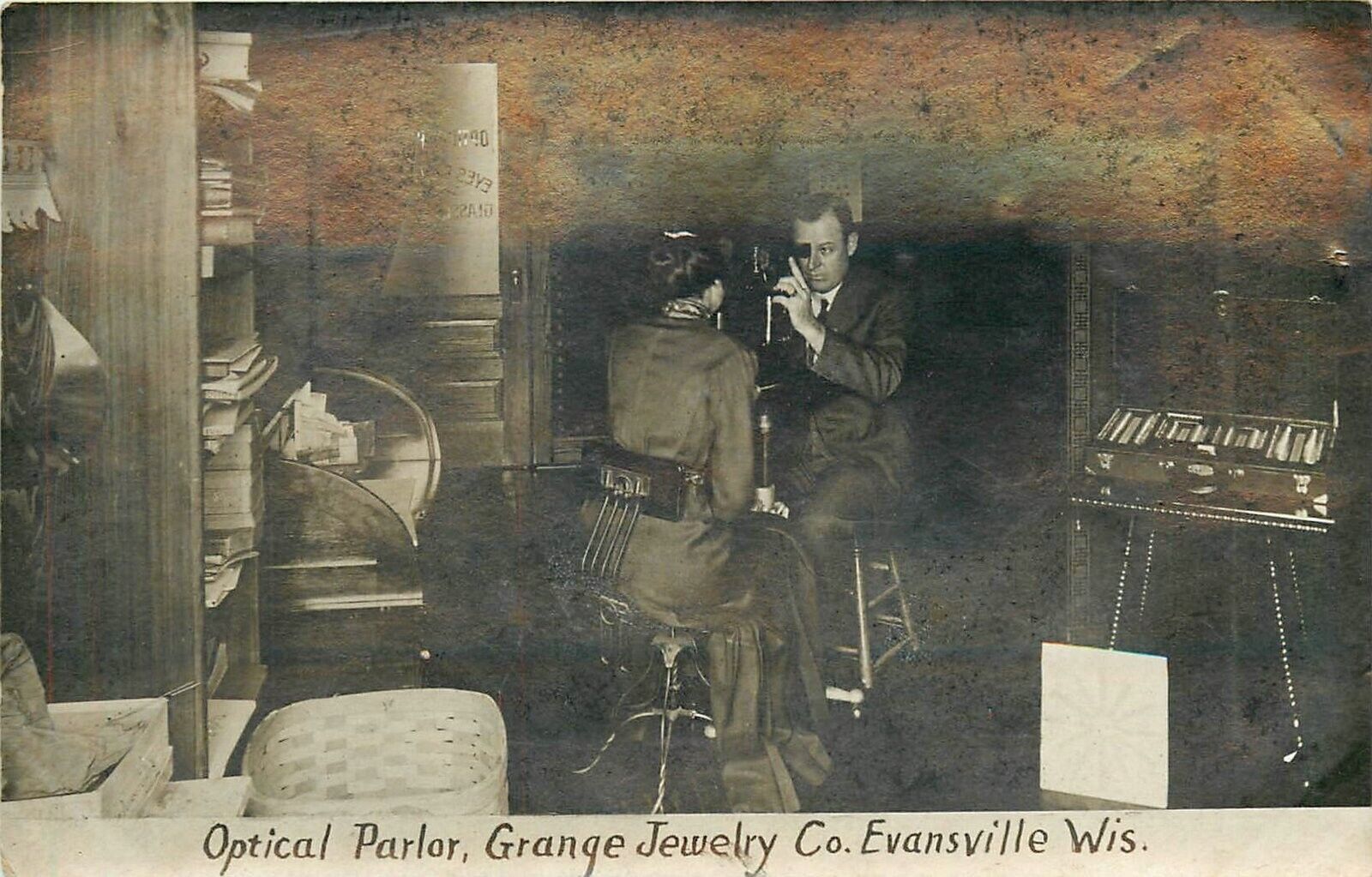 Postcard RPPC 1916 Wisconsin Evansville Optical Parlor Grange WI24-1007