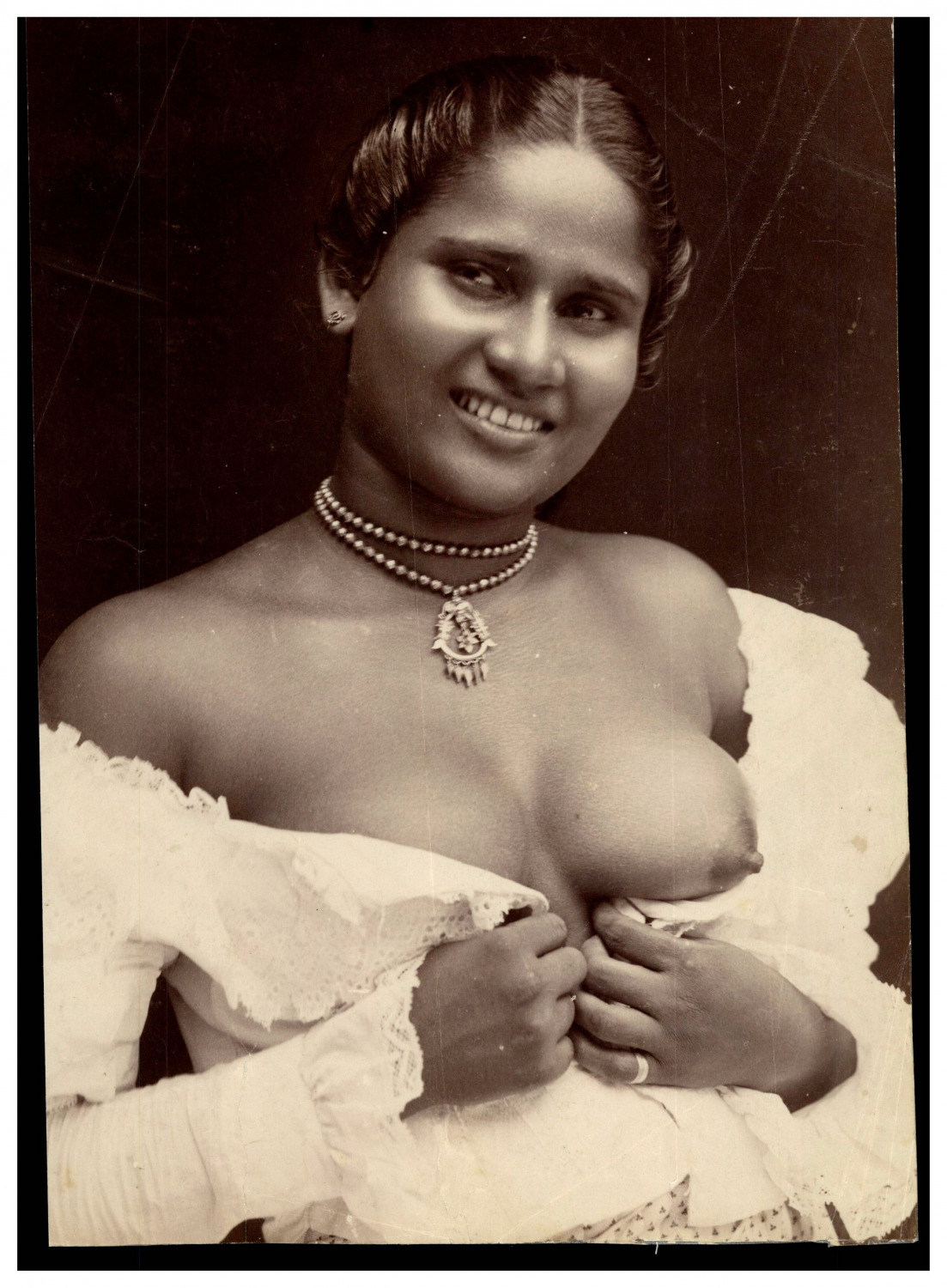 La nurse, woman revealing a breast, Colombo, Ceylon Sri Lanka vintage print.  