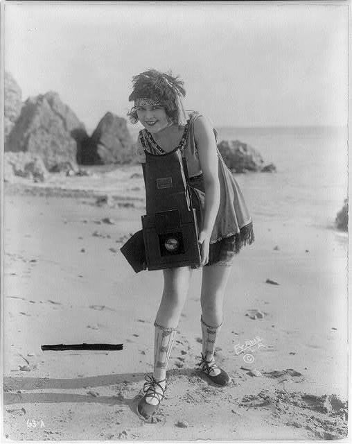 Photo:Myrtle Lind,young woman posed with Graflex camera,beach