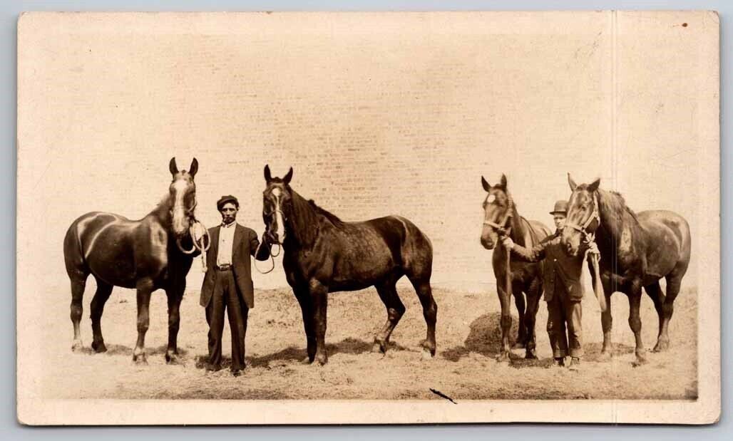 eStampsNet - RPPC Two Men Holding Horses out in Field Postcard 