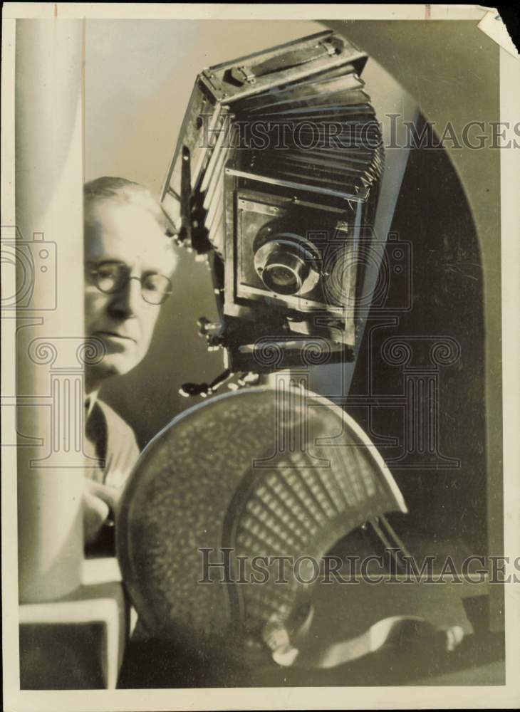 1938 Press Photo N.B. Aukerman fixing a camera - nei61681