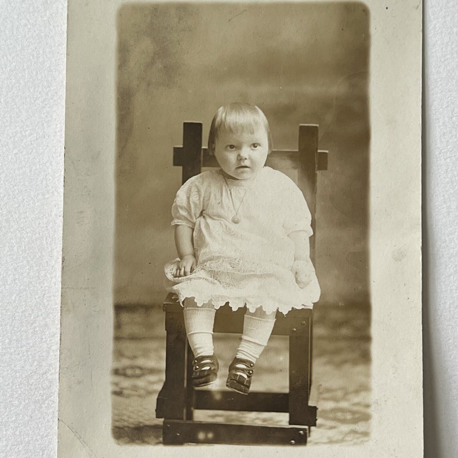 Antique RPPC Photograph Postcard Adorable Little Girl In Primitive Chair Locket
