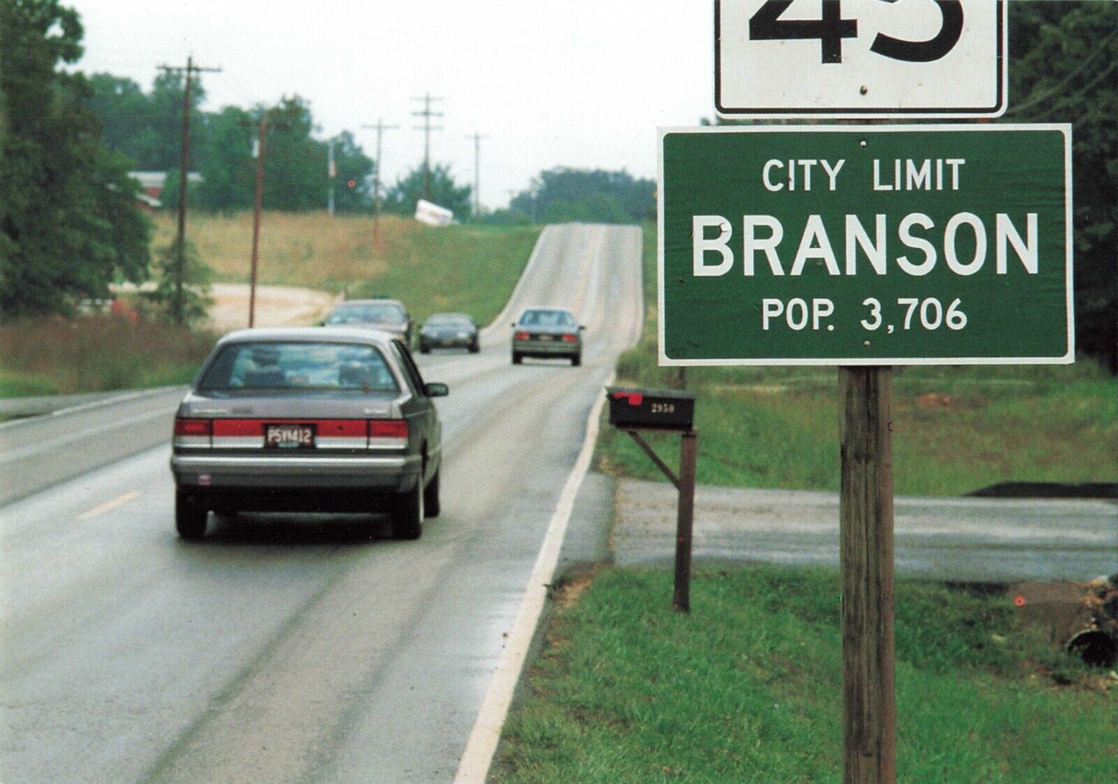 Branson MO Missouri, City Limit Sign 90s Cars Country Road, Vintage Postcard