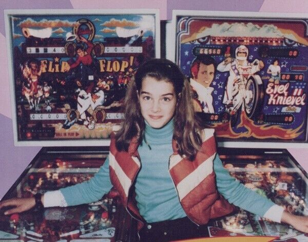 Brooke Shields poses next to pinball machines 1979 Tilt vintage 8x10 inch photo