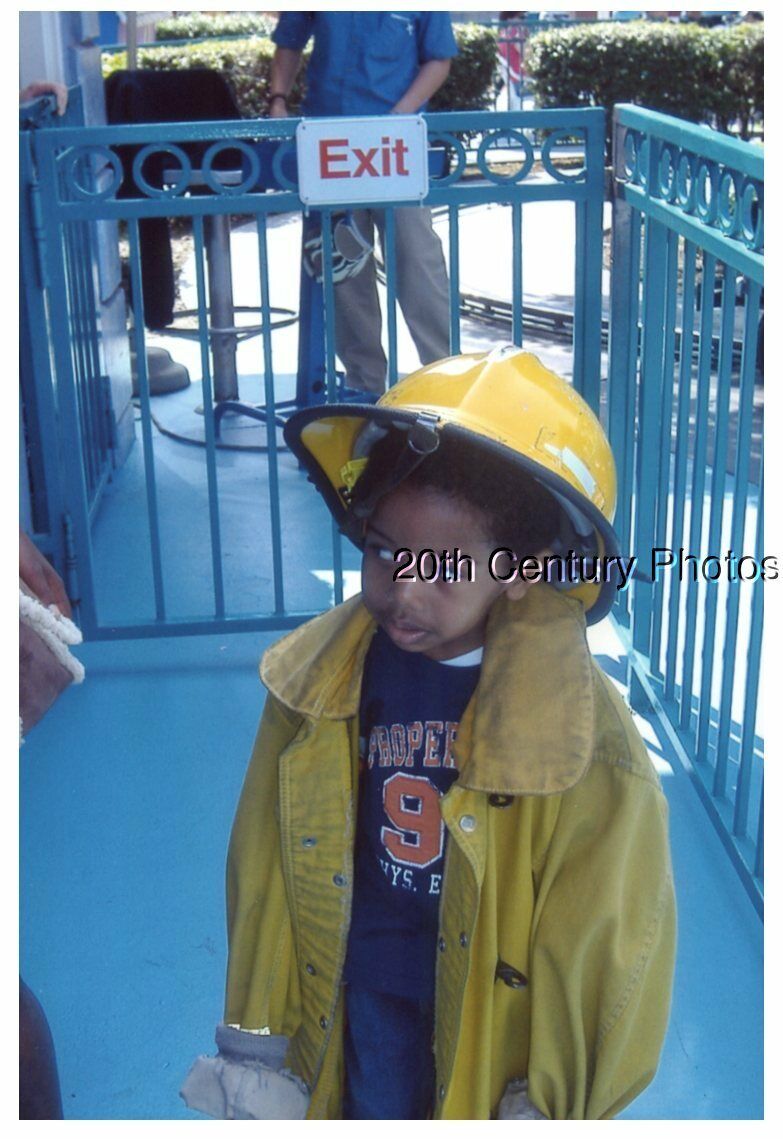 FOUND COLOR PHOTO J+5765 BOY IN FIREMANS OUTFIT AND HELMET