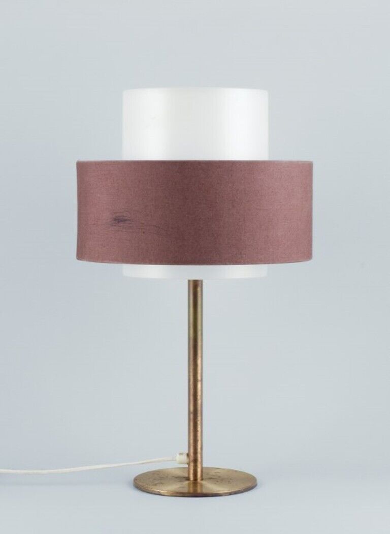 Luxus, Sweden. Large table lamp in brass with a shade in plastic and fabric.