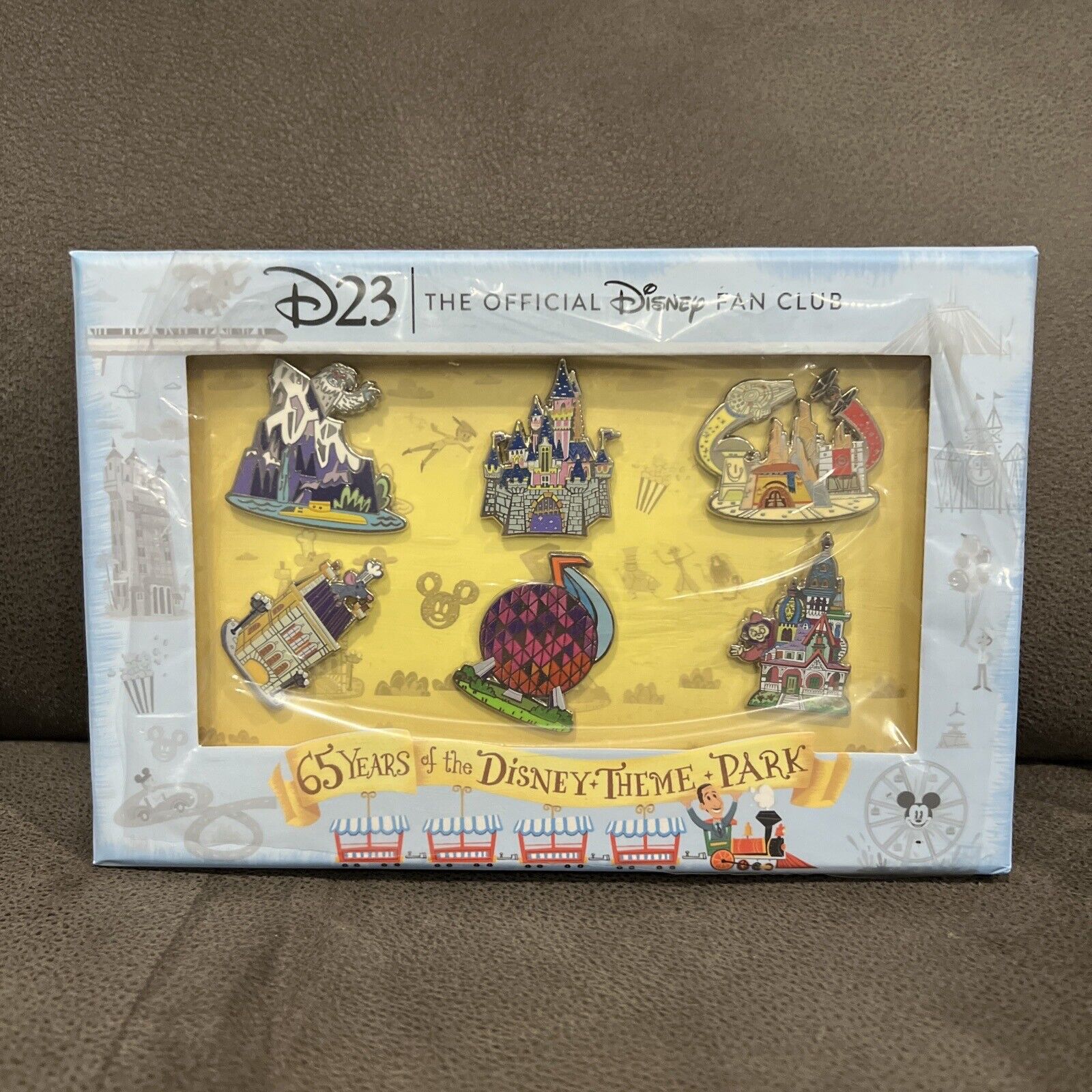  D23-EXCLUSIVE PIN SET CELEBRATES 65 YEARS OF THE DISNEY THEME PARKS