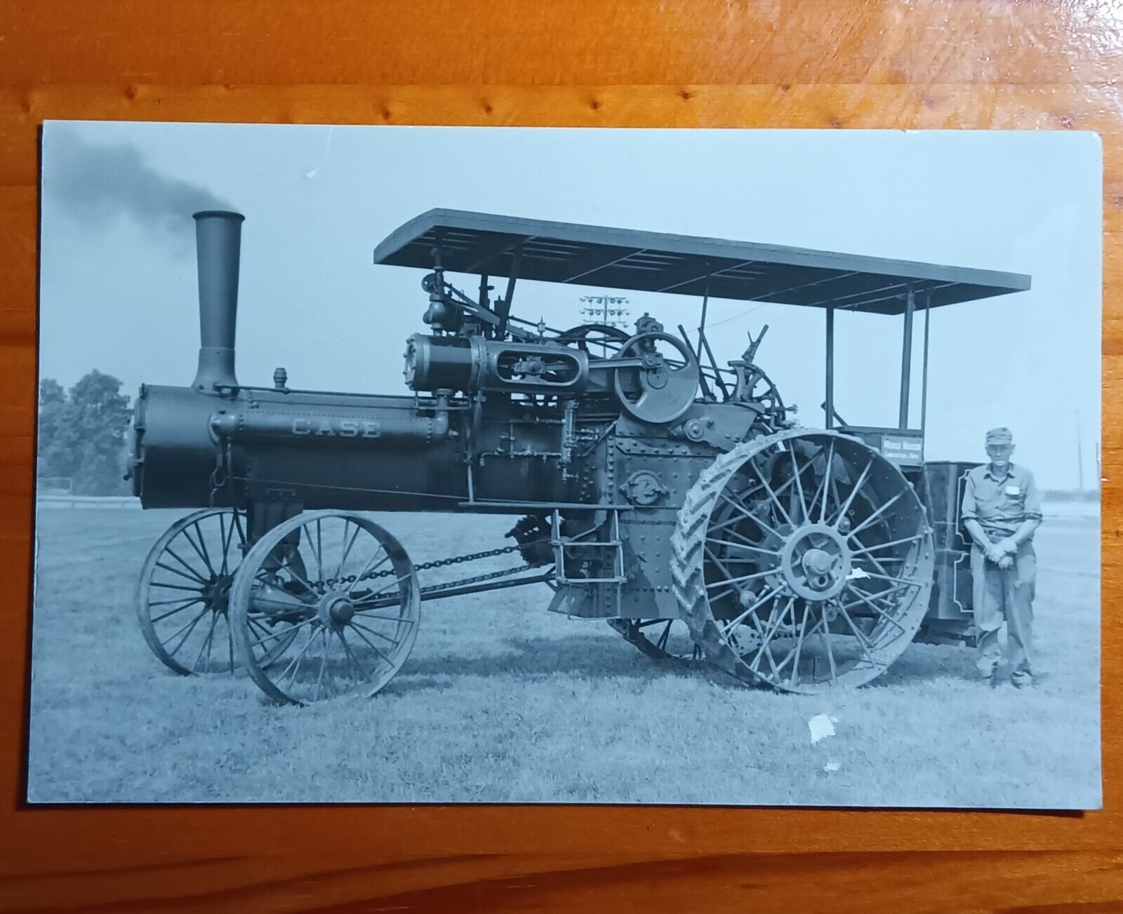 rppc of an ohio case steam tractor, standing beside the proud owner.