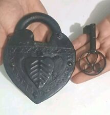 Giant old royal lock in the shape of a large heart with its original black key picture