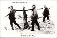 GARRISON, North Dakota RPPC Photo Postcard Hunting Exaggeration / Big Rabbit picture