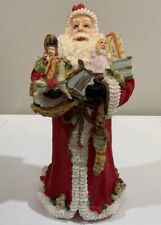Vtg Resin Santa Claus Holding Toys Musical Instruments Book Holly Berry Figurine picture