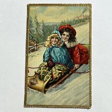 Antique Postcard Embossed Christmas Children Girls Sled Riding In Snow Sleigh picture