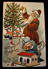 Fancy Red Robe Santa Claus Decorates Tree~Toys~Antique Christmas~Postcard~k383 picture