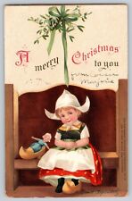 Postcard Merry Christmas Signed Ellen Clapsaddle Dutch Girl With Doll Clogs 1912 picture