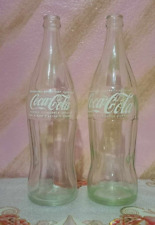 tow vintage Coca-Cola bottles of 77 CL arabic writting old moroco and one line picture