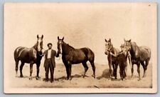 eStampsNet - RPPC Two Men Holding Horses out in Field Postcard  picture