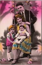c1910s European Tinted Photo RPPC Greetings Postcard Family on Swing 