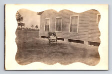 RPPC Baby Seated in Rocking Chair in Yard Odd Postcard picture