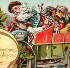 c.1907 Blue Robe Coat Santa Claus Driving Car Full of Toys Christmas Postcard picture