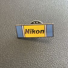 Vintage Nikon Lapel Pin Yellow Blue Black Lettering picture