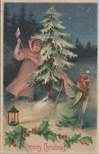 Postcard A Merry Christmas Girls Chopping Down a Christmas Tree  picture