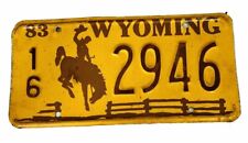VINTAGE 1983 WYOMING LICENSE PLATE BUCKING BRONCO /FENCE 16-2946 picture