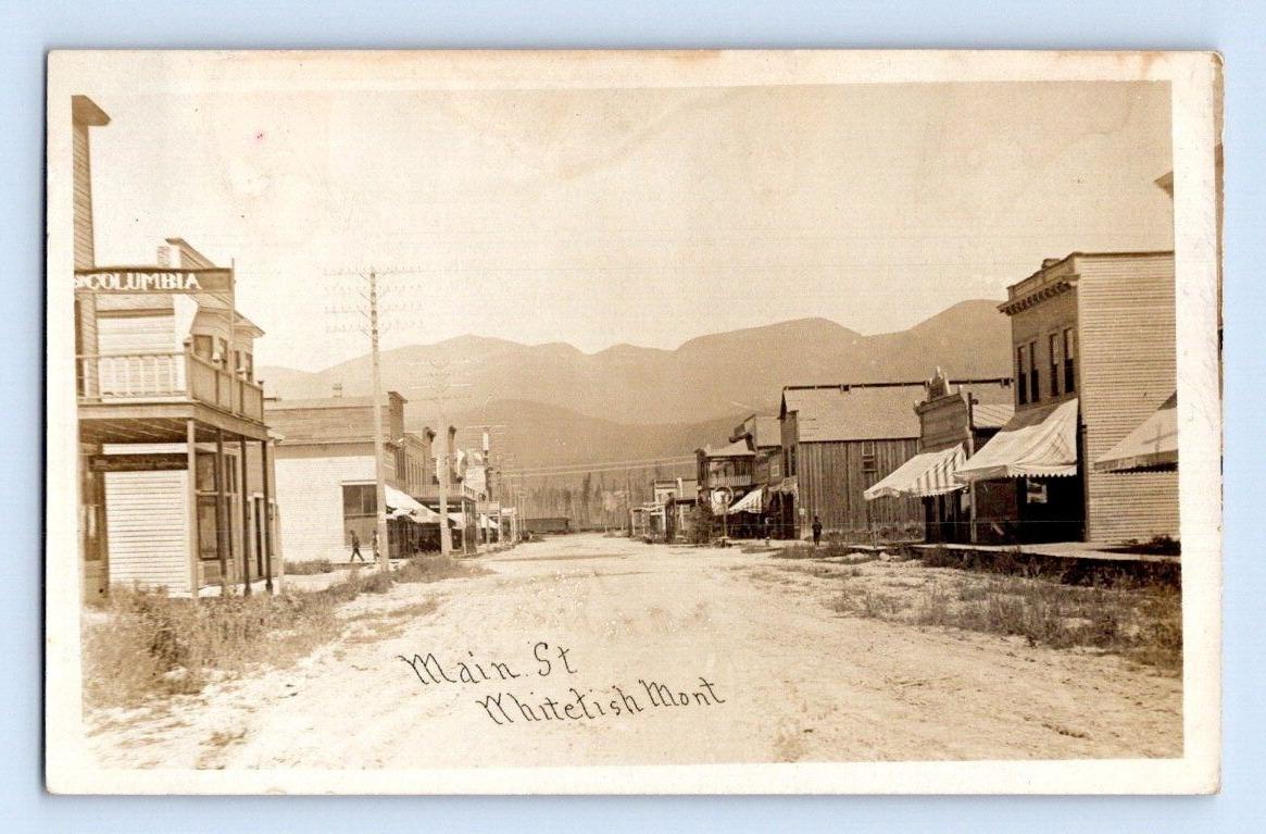 RPPC 1910. MAIN ST. WHITEFISH, MONTANA. STREET VIEW SHOPS. POSTCARD SZ23