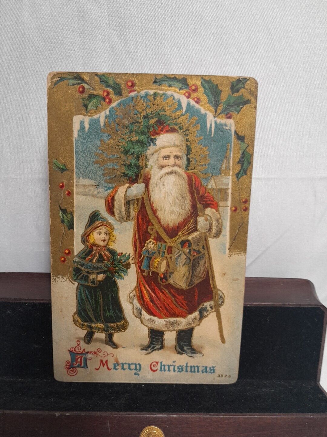 1909 Old World Santa Christmas Postcard Embossed Girl in Green Holly 3523