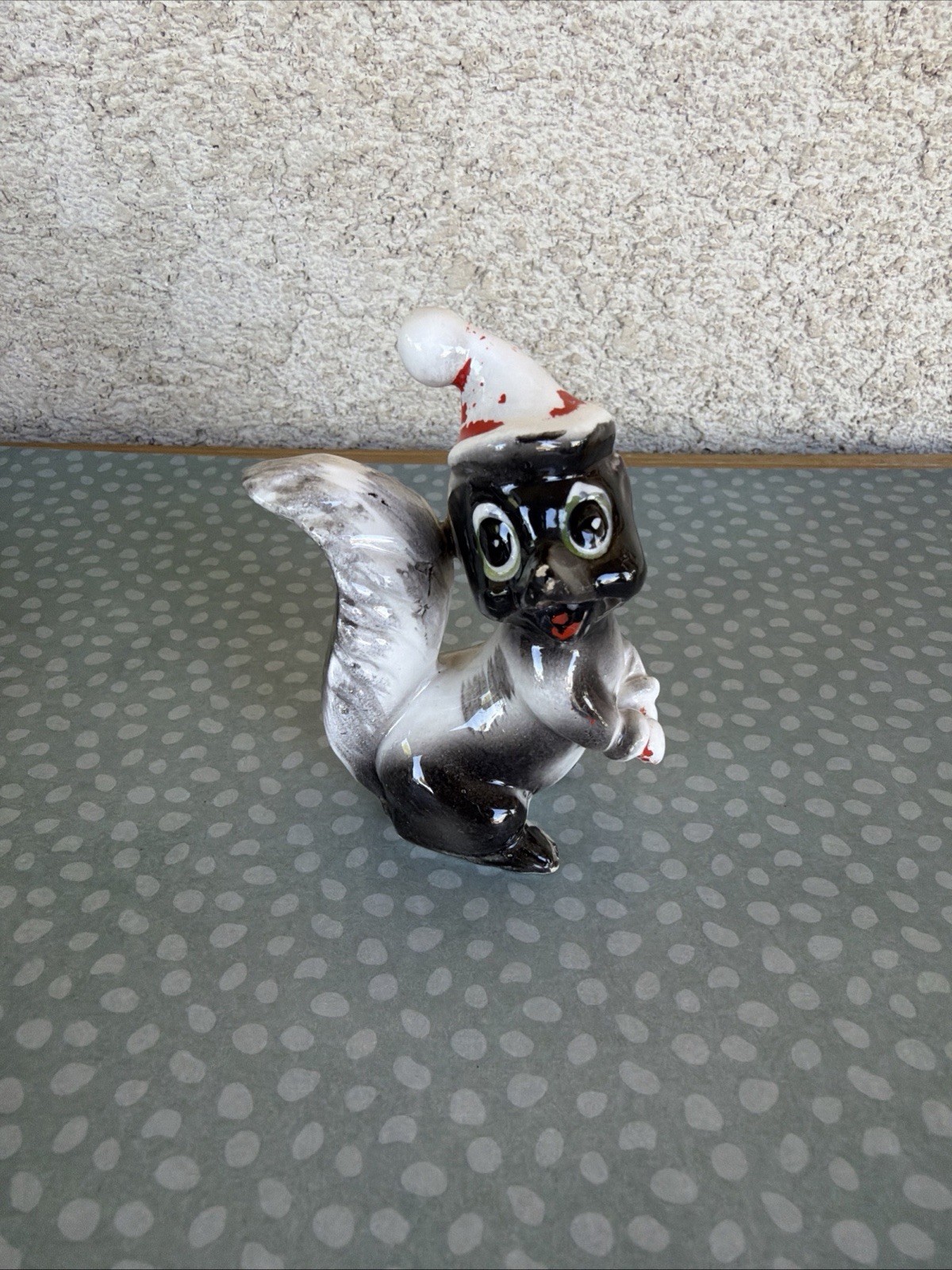 Ceramic Skunk Figurine Wearing White & Red Santa Hat, Approx 3 in Tall