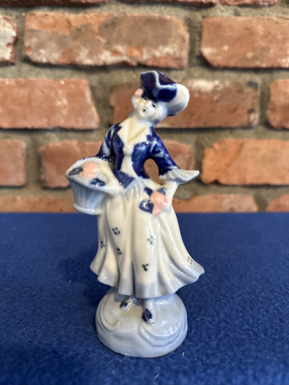 VINTAGE OCCUPIED JAPAN BLUE AND WHITE COLONIAL LADY WITH FLOWER BASKET FIGURINE