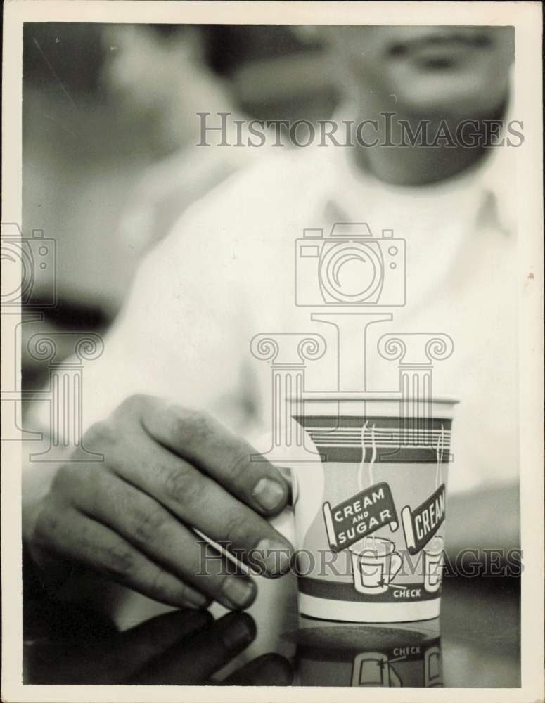 1959 Press Photo Man drinks coffee from paper cup - lrs24089