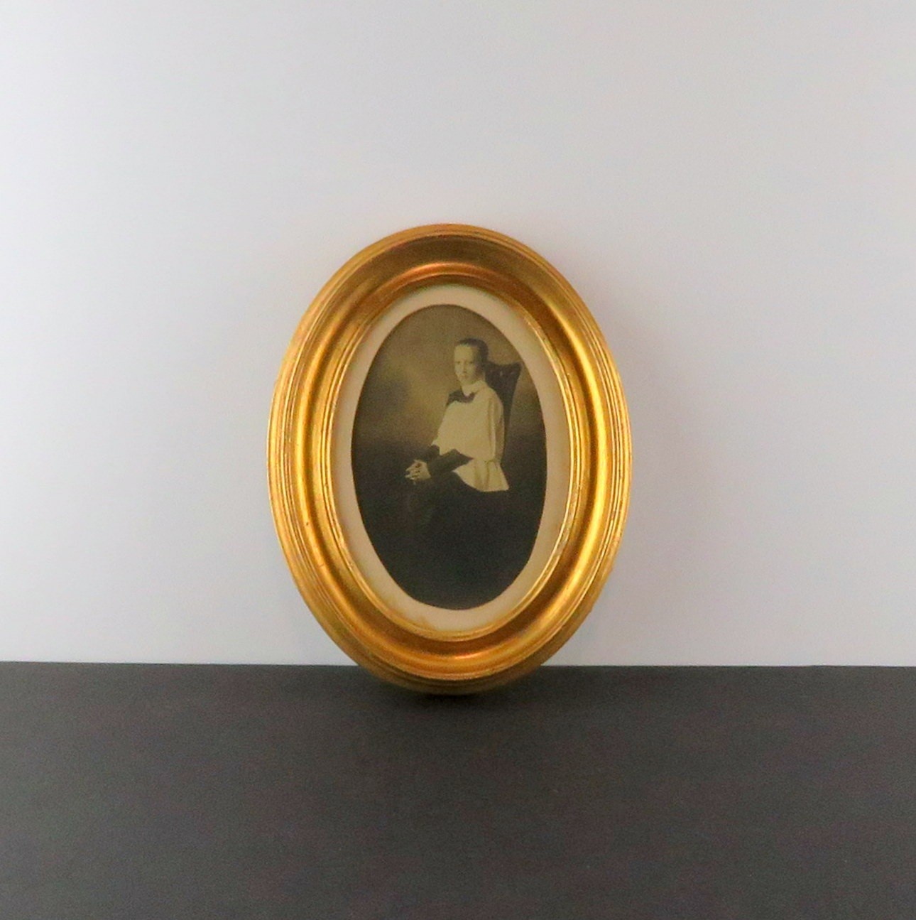 Catholic Altar Boy seated in chair, slick hair, ca 1900s Vintage Photo in Frame
