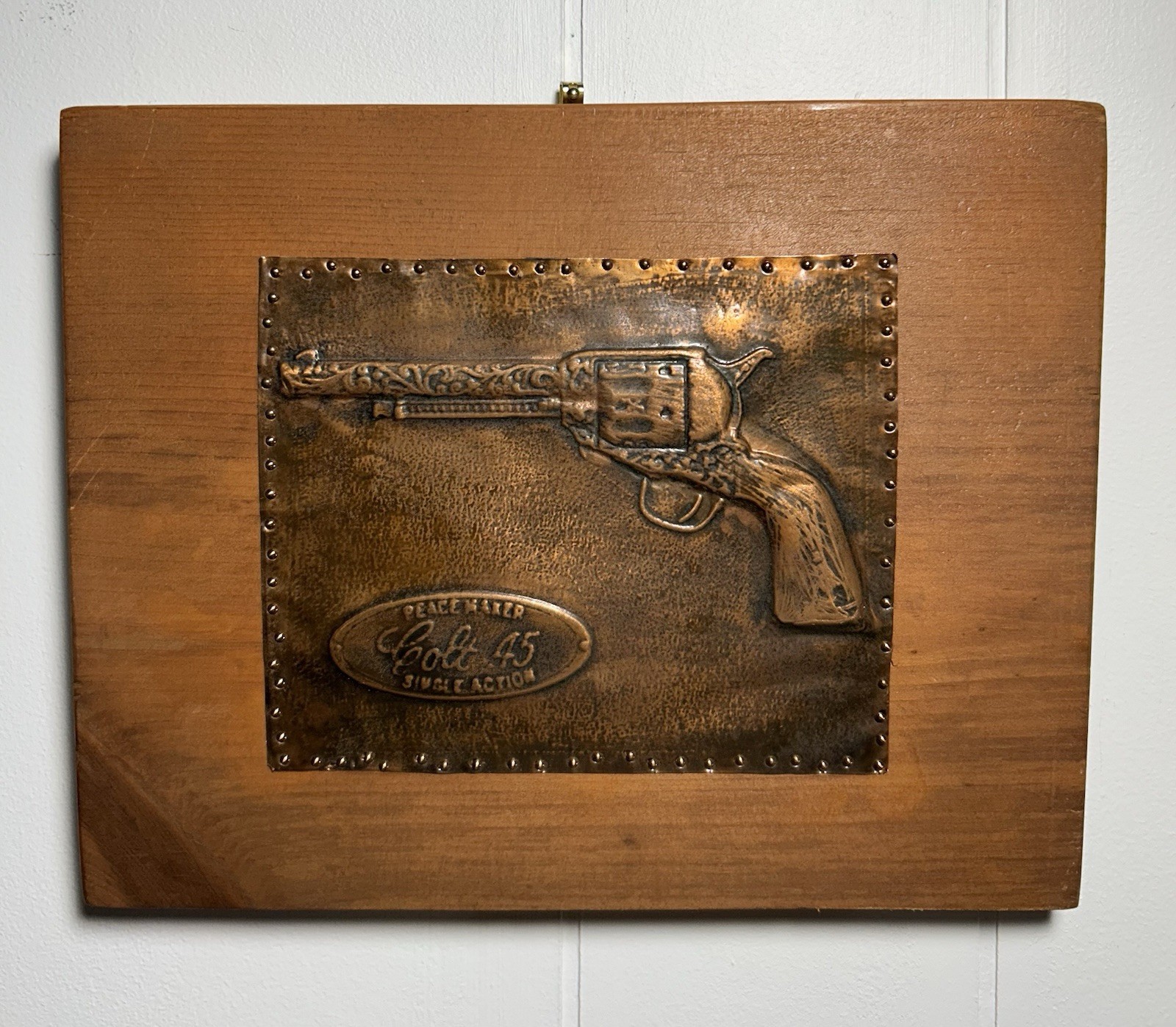 Vintage wooden wall plaque embossed copper plate Colt .45 Single Action revolver