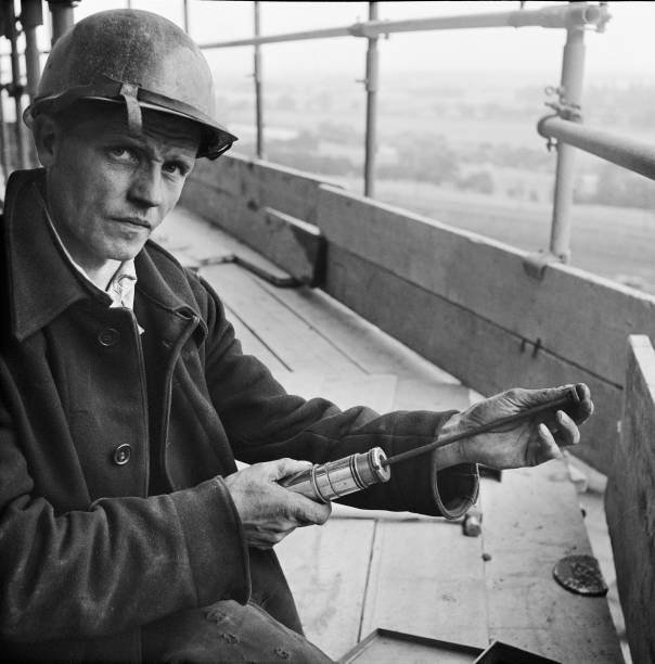 Worker loading a riveting gun during the construction of two sugar - Old Photo