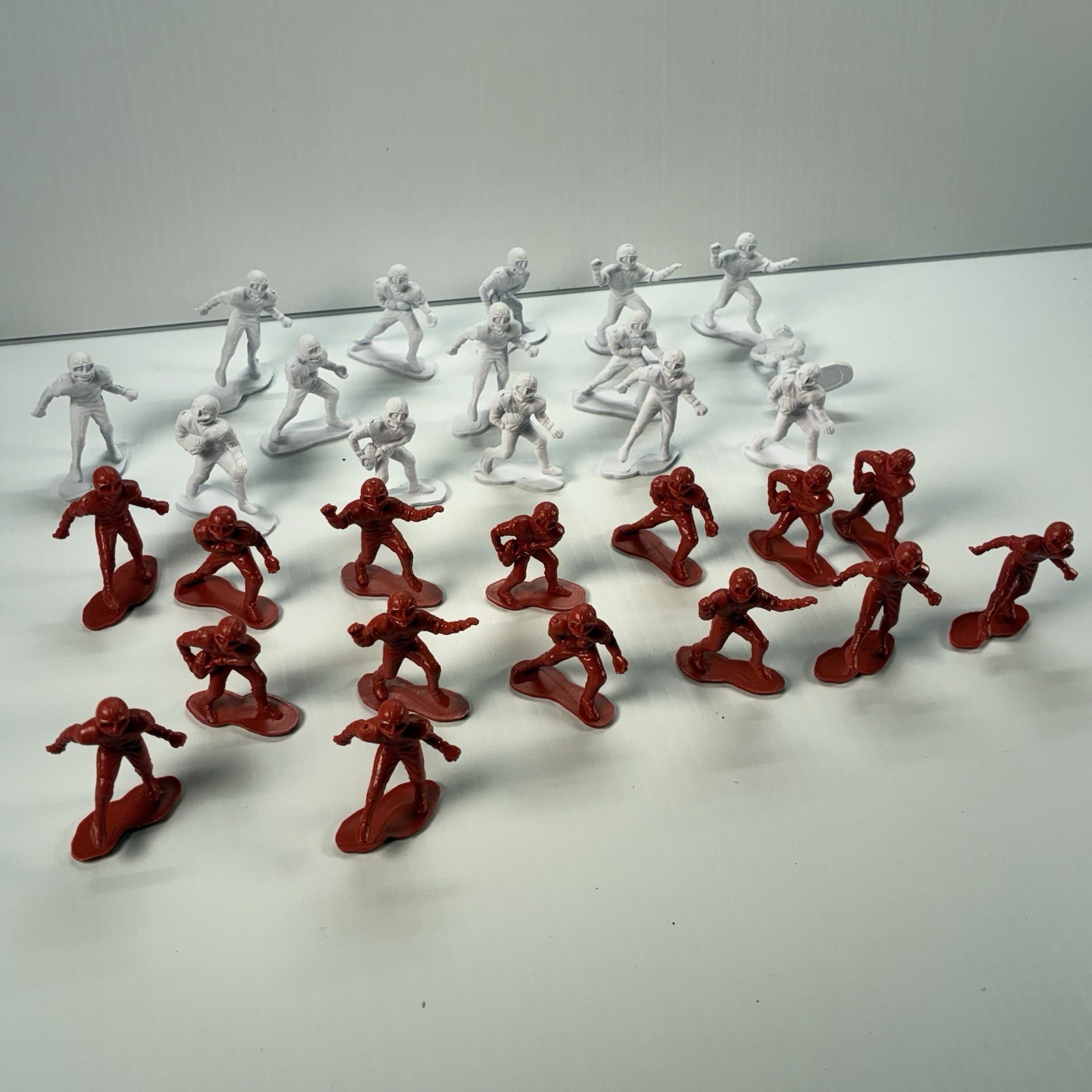 Plastic Football Figurines.  Lot Of 30.  Red & White.  Roughly 1.5”.  Sports
