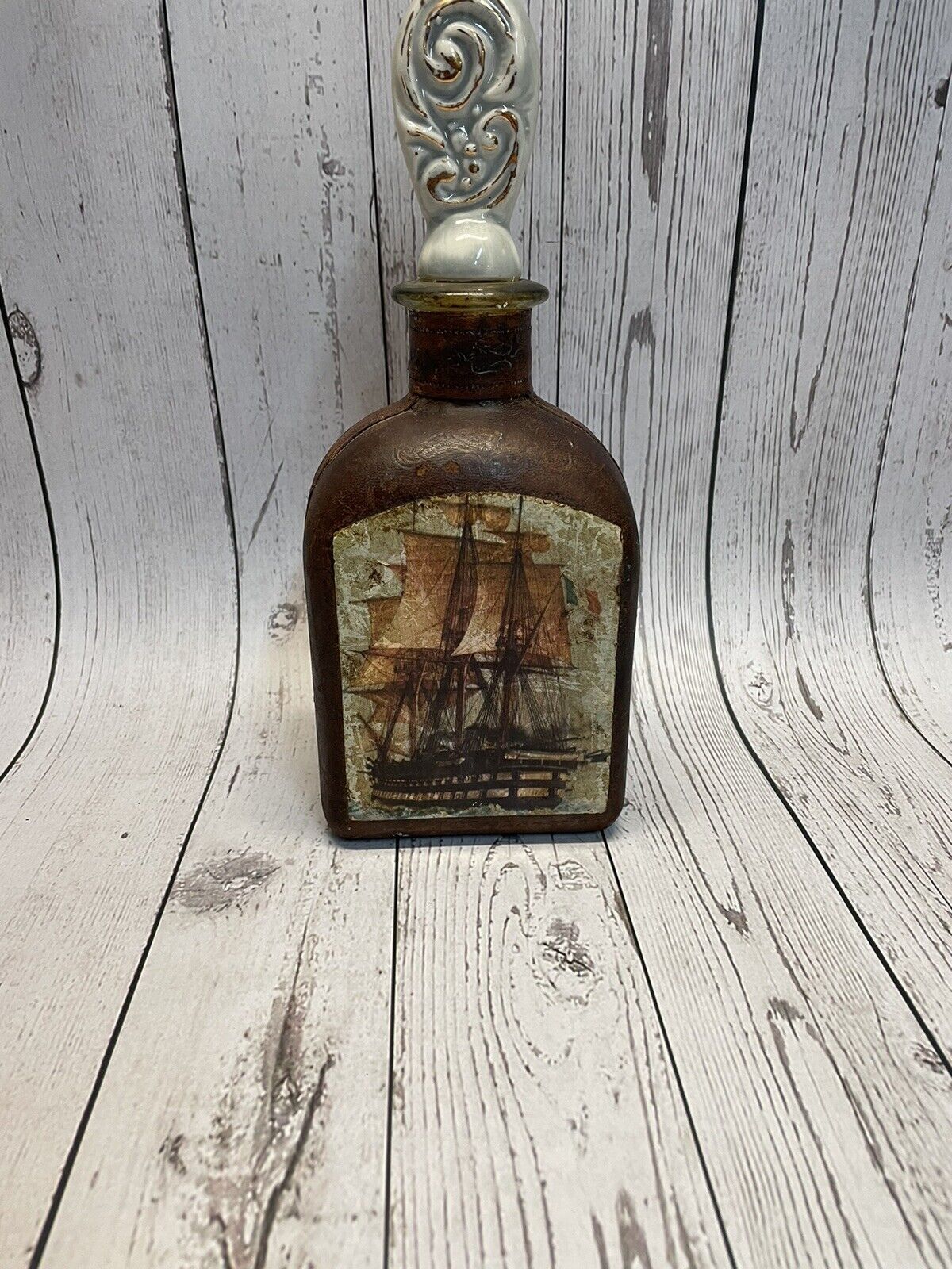 Vintage Italian leather wrapped decanter  Tooled Inset Images Of Ships W/stopper