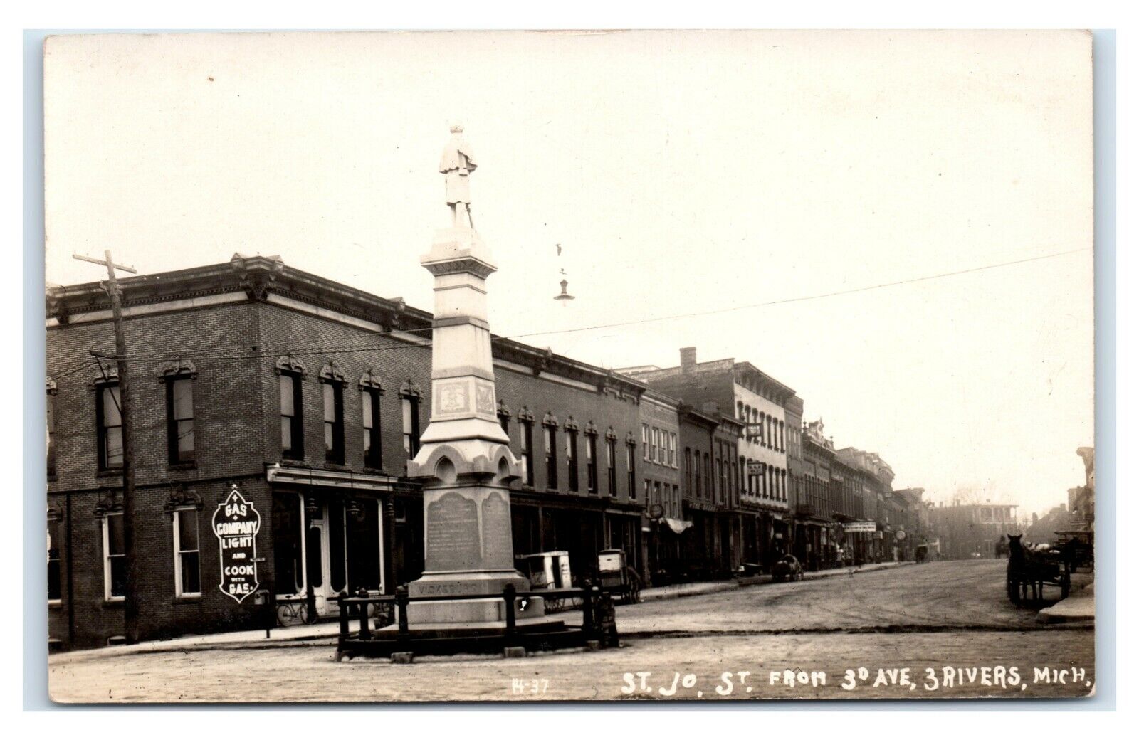 Postcard St Jo St from 3rd Ave, Three Rivers, Michigan Monument gas co RPPC L23