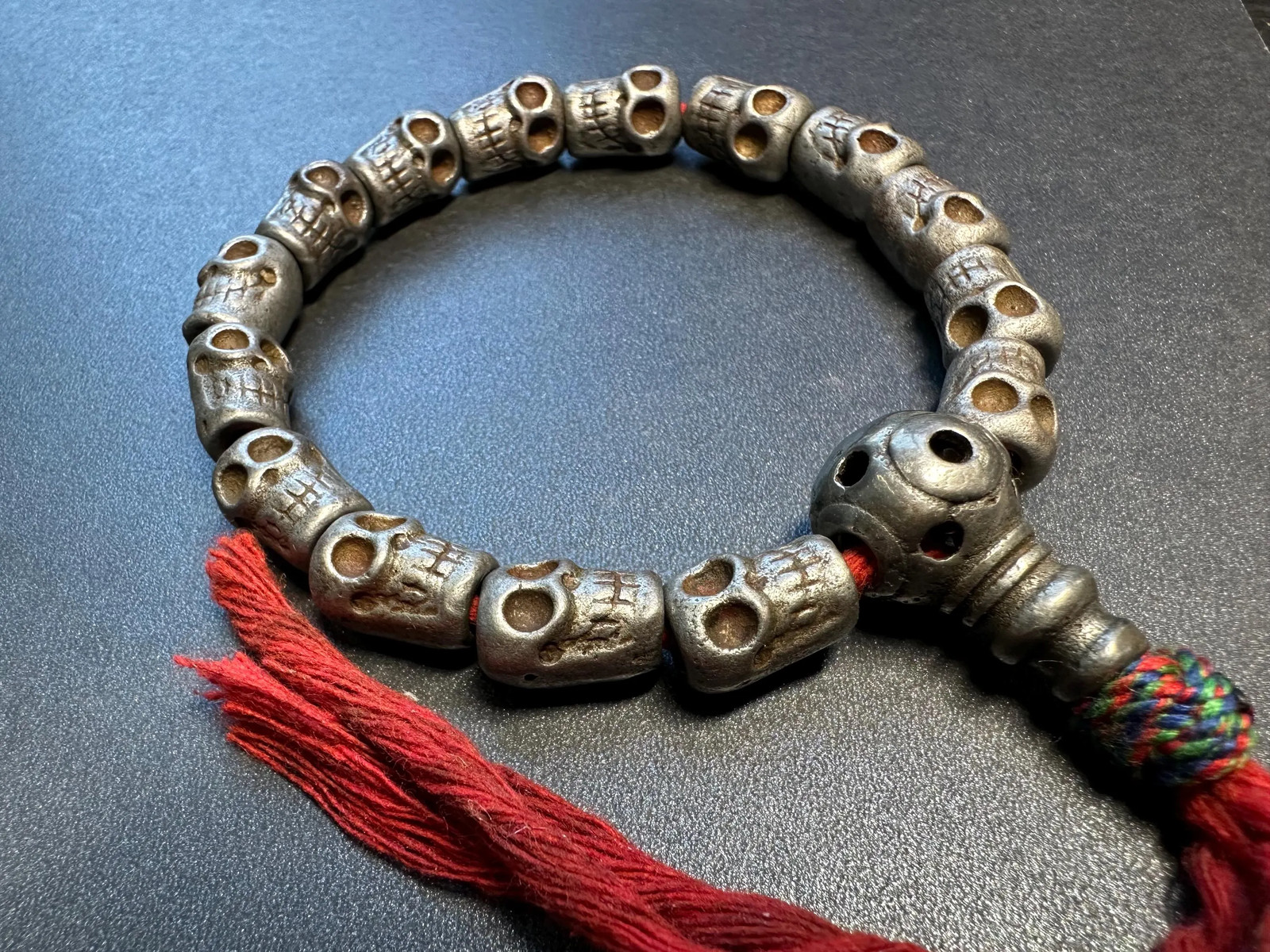 Tibetan Iron Skull Wrist Mala Bracelet | 10mm Charnel Ground Beads, Red Tassel,