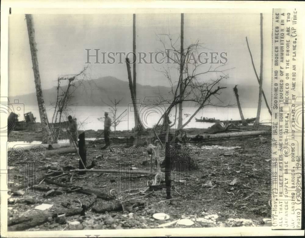 1942 Press Photo men walk the remains of Japanese ammunition base in New Guinea