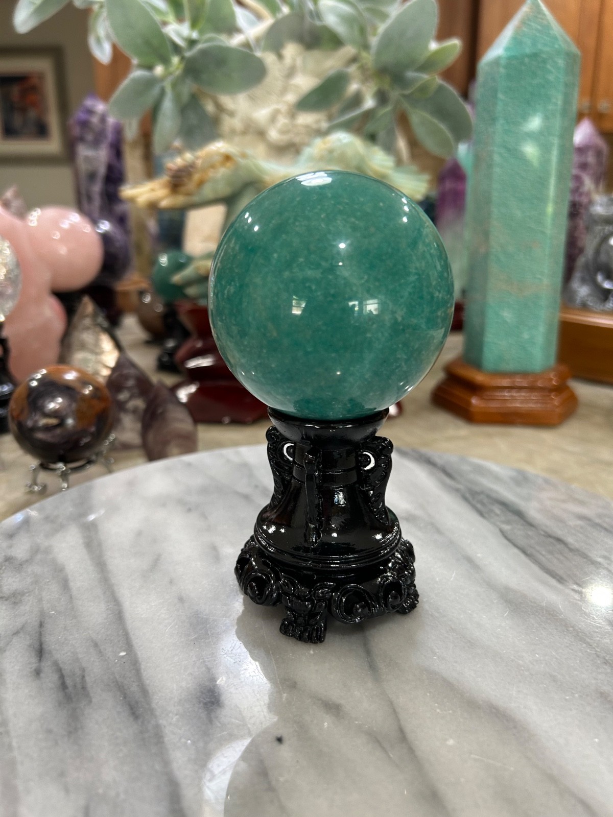Amazonite high grade sphere with black resin stand 2.80”